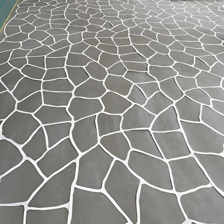 Close-up of grey concrete with a white crazy-paving pattern