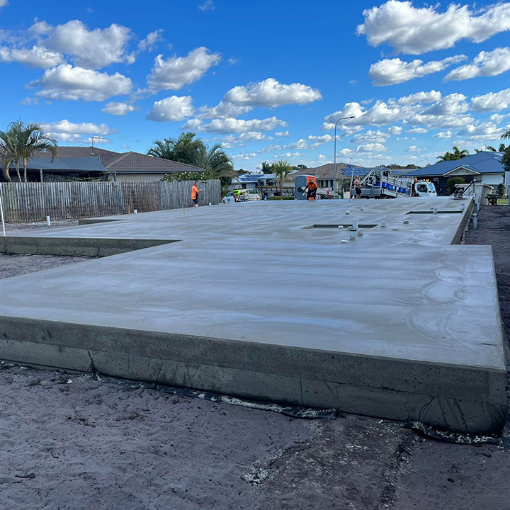 Large flat concrete slab poured on a cleared house block